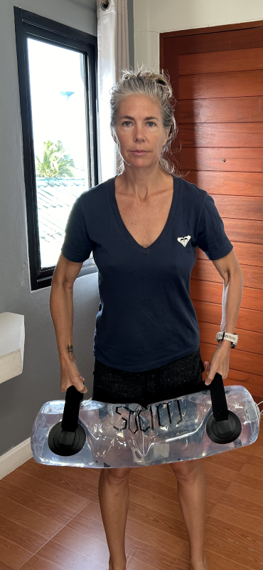 Dr. Freeze working out with portable “water filled “ weights in her hotel room